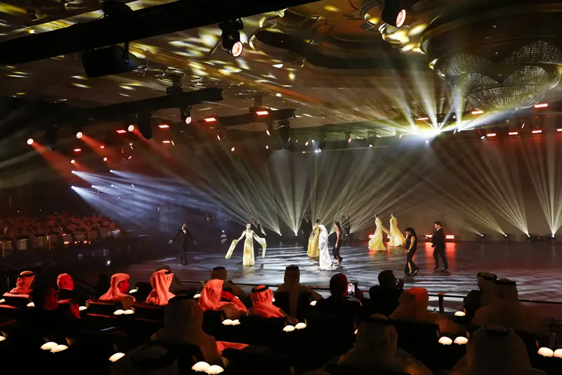 Dancers in warm light on the LED pitch